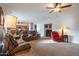 Bright open-concept living room with ceiling fan; kitchen and dining area visible at 3581 W Mineral Butte Dr, San Tan Valley, AZ 85144