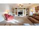 Inviting living room with built-in shelving, a ceiling fan, and comfortable leather furniture at 3581 W Mineral Butte Dr, San Tan Valley, AZ 85144