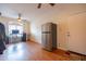 Bright living area with tile floors, ceiling fan, and office setup; stainless steel refrigerator visible at 3581 W Mineral Butte Dr, San Tan Valley, AZ 85144