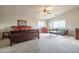 Spacious main bedroom with seating area, ceiling fan, and plenty of natural light at 3581 W Mineral Butte Dr, San Tan Valley, AZ 85144