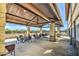 Covered outdoor patio with seating, stone pillars, and mountain views for comfortable gatherings at 3581 W Mineral Butte Dr, San Tan Valley, AZ 85144