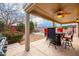 Charming covered patio with a ceiling fan and outdoor seating perfect for enjoying backyard views at 3581 W Mineral Butte Dr, San Tan Valley, AZ 85144