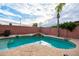 Inviting backyard pool with a rock waterfall feature, perfect for relaxation and outdoor entertainment at 3581 W Mineral Butte Dr, San Tan Valley, AZ 85144