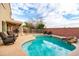 Backyard pool area, complete with a rock waterfall feature and comfortable lounge chairs at 3581 W Mineral Butte Dr, San Tan Valley, AZ 85144