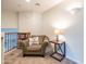 Cozy carpeted sitting area with chair, side table, and bookcase at 3581 W Mineral Butte Dr, San Tan Valley, AZ 85144