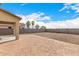 Spacious backyard featuring a covered patio, neutral block fence, and palm trees at 35973 W Velazquez Dr, Maricopa, AZ 85138