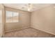 Bedroom with a ceiling fan, window with blinds, and carpeted floor at 35973 W Velazquez Dr, Maricopa, AZ 85138