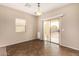 Dining area with tile flooring, sliding glass doors to backyard, and a modern light fixture at 35973 W Velazquez Dr, Maricopa, AZ 85138