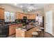 Bright kitchen featuring stainless steel appliances, an island with seating, and ample countertop space at 35973 W Velazquez Dr, Maricopa, AZ 85138