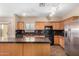 Bright kitchen with stainless steel appliances, granite countertops, and ample cabinet space at 35973 W Velazquez Dr, Maricopa, AZ 85138