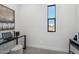 Minimalist office space featuring a small desk with stylish black metallic legs, natural light, and a neutral color palette at 377 E Windsor Ave # 16, Phoenix, AZ 85004