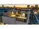 An aerial view of a rooftop deck shows a dining table and chairs at sunset at 377 E Windsor Ave # 16, Phoenix, AZ 85004