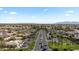 High angle aerial shot shows palm tree lined streets in a well-kept golf course community with mountain views at 4068 N 155Th Ln, Goodyear, AZ 85395