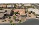 Aerial view of a home with desert landscaping, tile roof, and a brick paved driveway in a quiet neighborhood at 4068 N 155Th Ln, Goodyear, AZ 85395