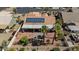 Aerial view of private backyard with desert landscaping, solar panels, and cozy outdoor firepit area at 4068 N 155Th Ln, Goodyear, AZ 85395