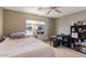 Neutral bedroom with a large window and ceiling fan at 4068 N 155Th Ln, Goodyear, AZ 85395