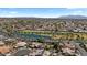 Wide aerial shot highlighting a well-manicured golf course and lake bordered by single-Gathering homes at 4068 N 155Th Ln, Goodyear, AZ 85395