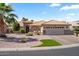 Beautiful home featuring well-maintained landscaping, desert rock and a tile roof at 4068 N 155Th Ln, Goodyear, AZ 85395