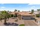 Attractive one-story home with a tile roof, a three-car garage, and desert landscaping with palm trees at 4068 N 155Th Ln, Goodyear, AZ 85395