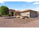 Home exterior showcasing a well-manicured yard, desert landscaping and charming details at 4068 N 155Th Ln, Goodyear, AZ 85395