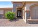 Charming home entrance with stone accents, a decorative door, and a professionally landscaped walkway at 4068 N 155Th Ln, Goodyear, AZ 85395