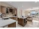 Kitchen with a center island, wood cabinets and view to a dining table near a window at 4068 N 155Th Ln, Goodyear, AZ 85395