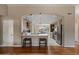 Open kitchen with wood floors and cabinetry, an island and pendant lighting above at 4068 N 155Th Ln, Goodyear, AZ 85395