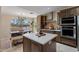 Bright kitchen with a view to a dining table near a window and stainless steel appliances at 4068 N 155Th Ln, Goodyear, AZ 85395