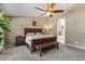 Cozy main bedroom with a ceiling fan, en-suite bathroom view and warm natural light at 4068 N 155Th Ln, Goodyear, AZ 85395