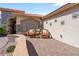 Exterior featuring a cozy patio with seating, desert landscaping and stylish architectural details at 4068 N 155Th Ln, Goodyear, AZ 85395