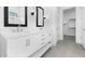 Modern bathroom featuring double vanity, mirrors, and tiled floors at 4395 N 203Rd Ave, Buckeye, AZ 85396