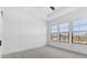 Well-lit bedroom featuring three windows and modern wall trim accents at 4395 N 203Rd Ave, Buckeye, AZ 85396