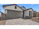 Charming single Gathering home featuring a spacious garage and tasteful desert landscaping at 4395 N 203Rd Ave, Buckeye, AZ 85396