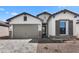 Beautiful single story home featuring a stone enhanced facade and desert landscaping at 4395 N 203Rd Ave, Buckeye, AZ 85396