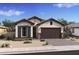 Charming single-story home features a welcoming facade with a two-car garage and attractive desert landscaping at 4395 N 203Rd Ave, Buckeye, AZ 85396