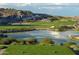 Picture of a verdant golf course landscape with a tranquil pond at 4395 N 203Rd Ave, Buckeye, AZ 85396