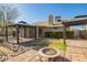 Spacious backyard featuring a fire pit, gazebos, desert landscaping, and brick pavers at 4865 E Princess Dr, Mesa, AZ 85205