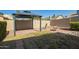 Backyard featuring a gazebo, brick ground, rock bed, and block fence at 4865 E Princess Dr, Mesa, AZ 85205