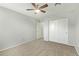 A cozy bedroom with a ceiling fan and a closet with doors at 4865 E Princess Dr, Mesa, AZ 85205