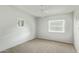 Cozy bedroom features wood paneled walls, carpet, and a ceiling fan at 4865 E Princess Dr, Mesa, AZ 85205