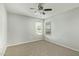 Bright bedroom featuring two windows, ceiling fan, and neutral gray carpet at 4865 E Princess Dr, Mesa, AZ 85205