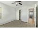 Bedroom featuring carpet, ceiling fan, and closet with partially opened doors at 4865 E Princess Dr, Mesa, AZ 85205