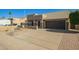 Exterior view showcasing the driveway and desert landscaping of this charming home at 4865 E Princess Dr, Mesa, AZ 85205