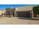 Inviting home featuring a two-car garage, desert landscaping, and a neutral color palette at 4865 E Princess Dr, Mesa, AZ 85205