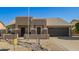 Inviting home featuring neutral colors, desert landscaping, and an attached two-car garage at 4865 E Princess Dr, Mesa, AZ 85205