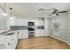 Modern kitchen features stainless steel appliances, white cabinetry, and hardwood floors at 4865 E Princess Dr, Mesa, AZ 85205