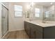 A well-lit bathroom featuring double sinks and a spacious shower with marble tiling at 4948 W Walatowa St, Laveen, AZ 85339