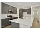 Well-equipped kitchen featuring stainless appliances, grey cabinets, and quartz countertops at 4948 W Walatowa St, Laveen, AZ 85339