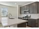 Modern kitchen featuring stainless steel appliances, grey cabinets, and a center island at 4948 W Walatowa St, Laveen, AZ 85339