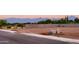 Empty land lot with mountain views and a curb ready for development at 4948 W Walatowa St, Laveen, AZ 85339